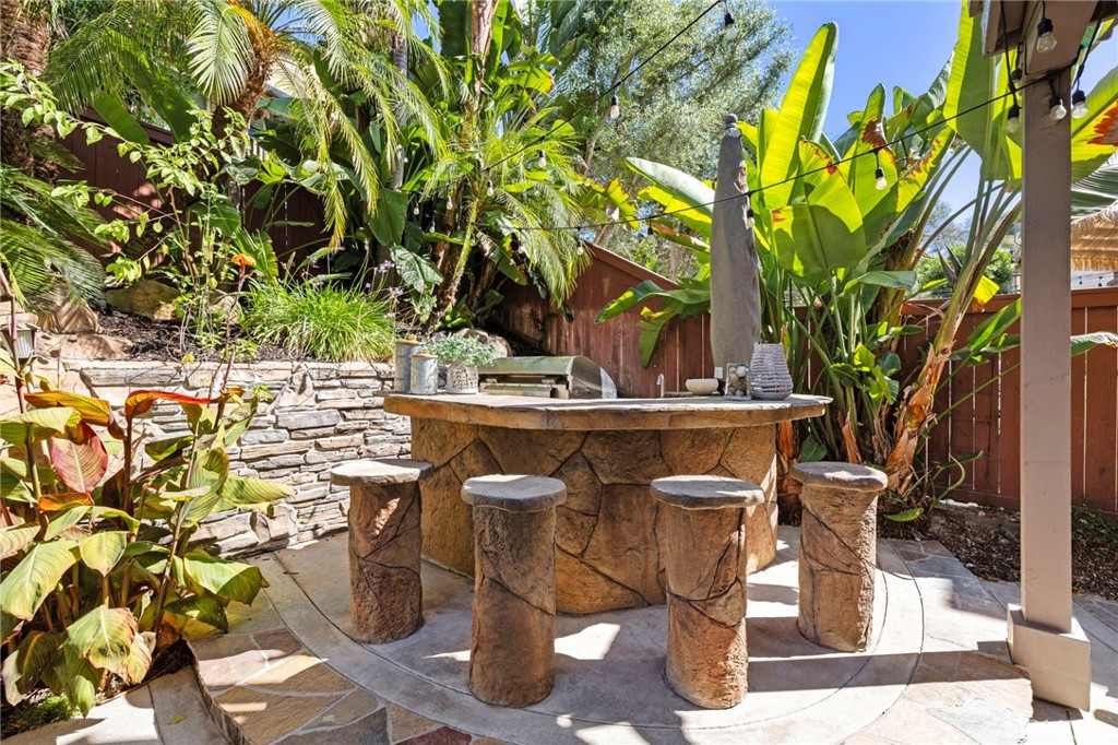 Built-in BBQ area with seating in the backyard. - 30 Acanthus, Rancho Santa Margarita CA 92688 - photo 38