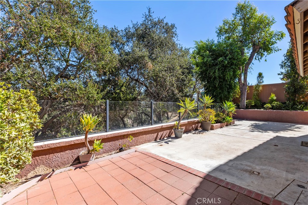 Private patio with mature trees - HOA maintained. - 30 San Bonifacio, Rancho Santa Margarita CA 92688 - photo 30