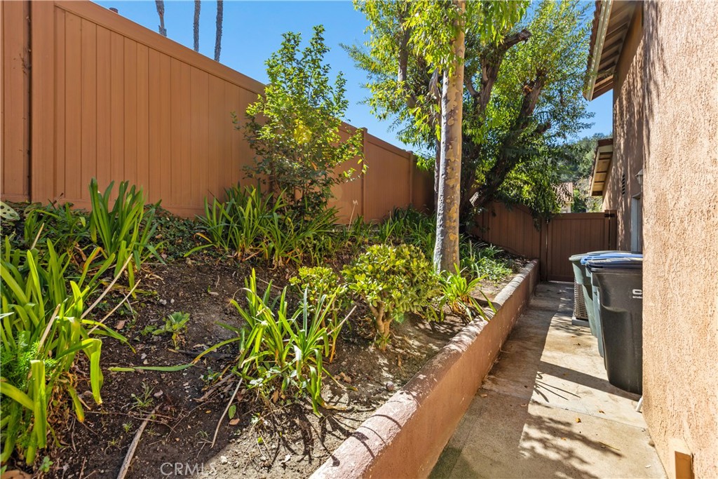 Side yard with updated vinyl fencing. - 30 San Bonifacio, Rancho Santa Margarita CA 92688 - photo 32