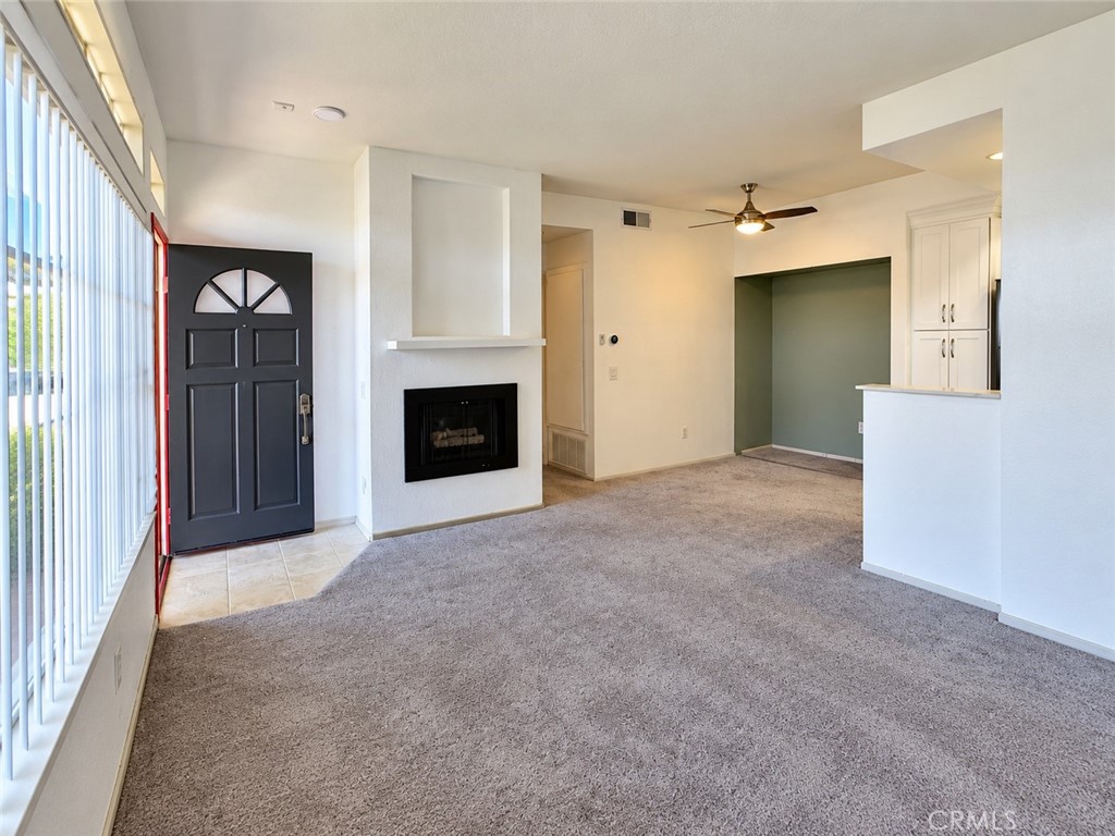Fireplace by entry door in the living room view - 9 De Lino, Rancho Santa Margarita CA 92688 - photo 10