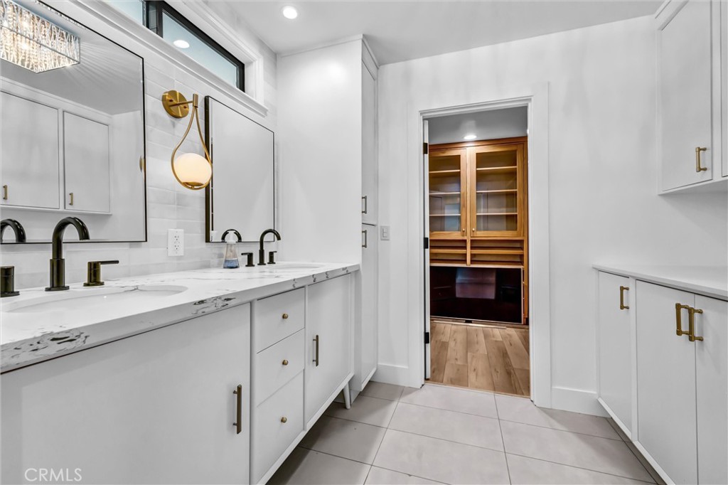 Primary bathroom walk in closet and dual vanity - 11444 Harrisburg Road, Rossmoor CA 90720 - photo 30