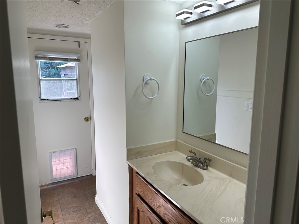 Hallway bath with a door leading to the patio and pool. - 3252 Orangewood, Rossmoor CA 90720 - photo 33