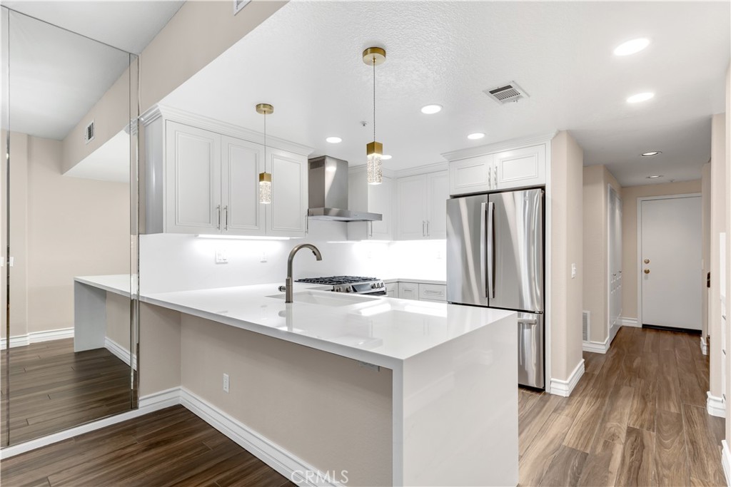 The quartz countertop feature a bartop eating area as well as a waterfall edge. - 1003 Via Presa, San Clemente CA 92672 - photo 1