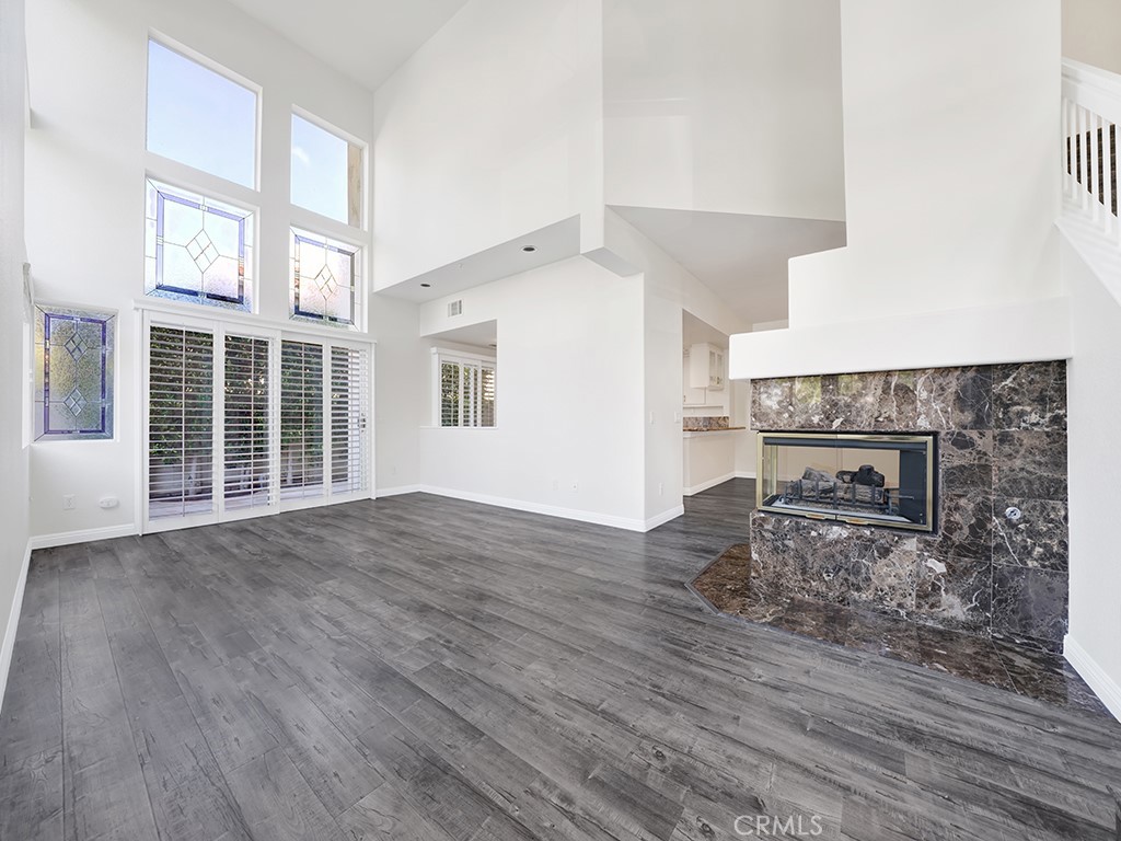 The living room features a gas fireplace, vaulted ceilings and a sliding door to your backyard. - 1031 Via Presa, San Clemente CA 92672 - photo 4