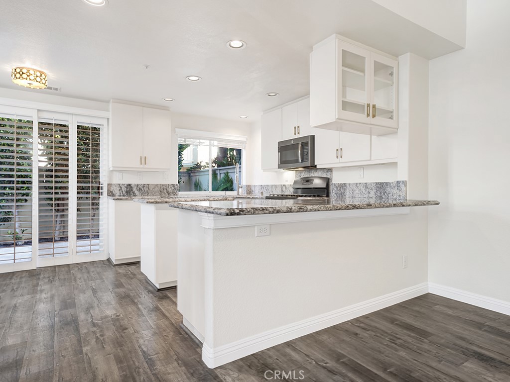 The kitchen has a bartop seating area as well as a sliding glass door to your backyard. - 1031 Via Presa, San Clemente CA 92672 - photo 9
