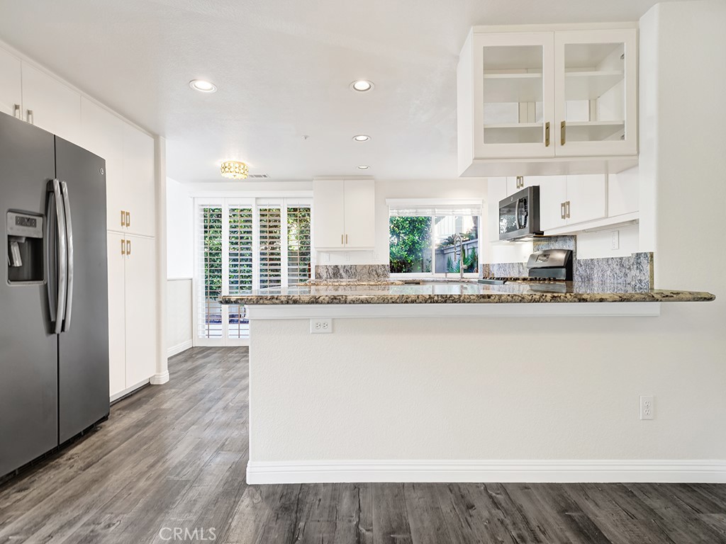 The kitchen is spacious, has plenty of space to cook and dine with it's functional layout. - 1031 Via Presa, San Clemente CA 92672 - photo 13