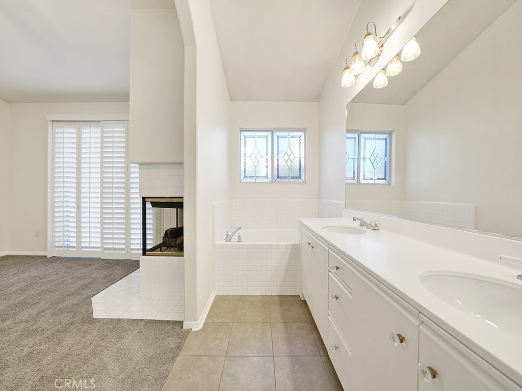 This is the primary bathroom that has dual sinks, a bathtub as well as a fireplace. - 1031 Via Presa, San Clemente CA 92672 - photo 19