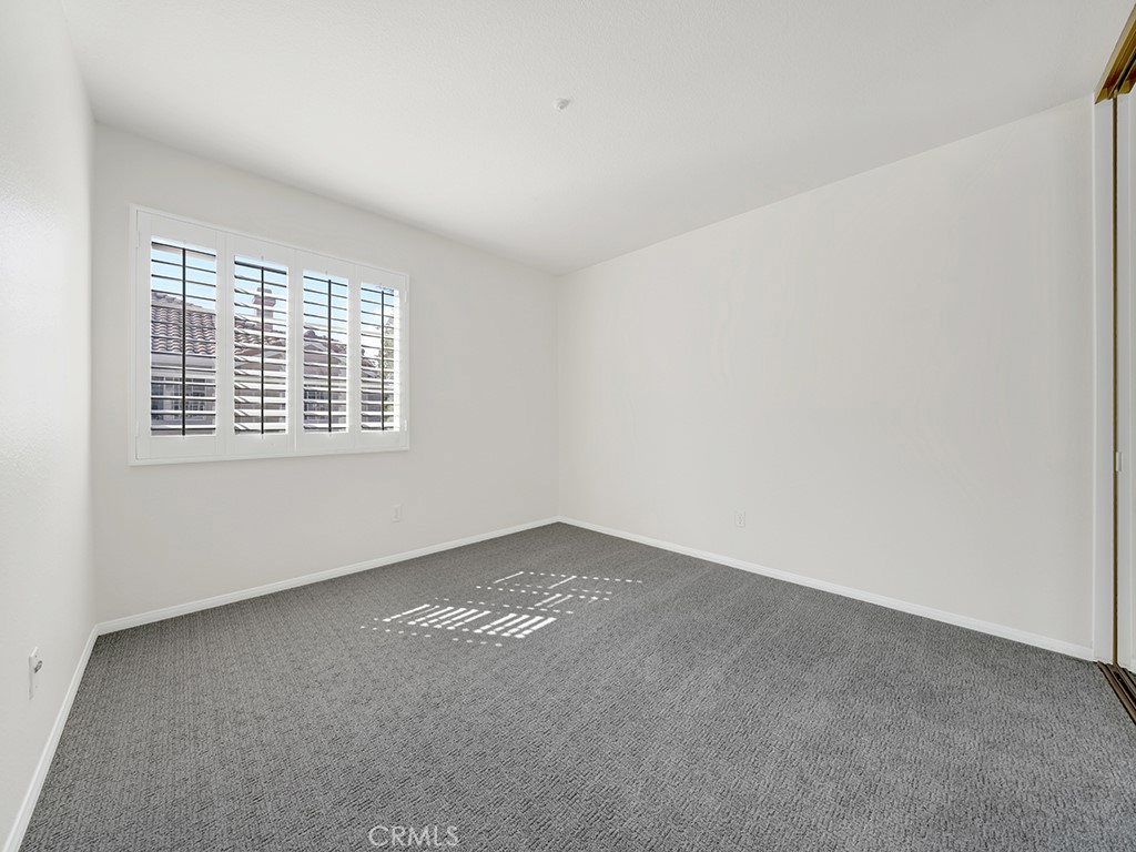 This guest bedroom has a mirrored closet. - 1031 Via Presa, San Clemente CA 92672 - photo 23