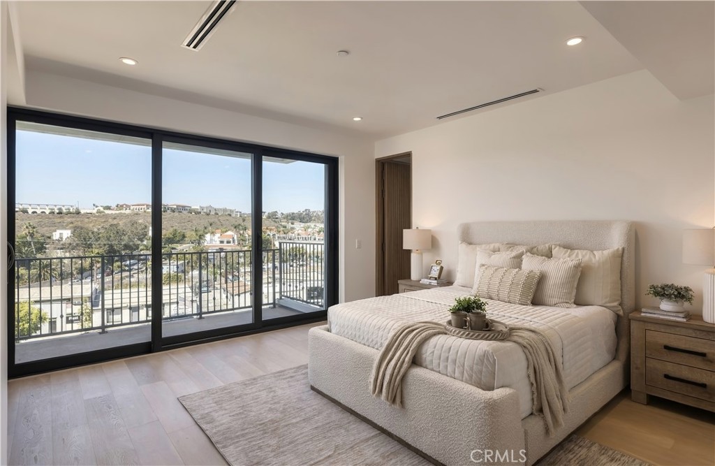 Primary suite: Floor-to-ceiling glass frames the hillside and city beyond. - 126 Calle Redondel, San Clemente CA 92672 - photo 35