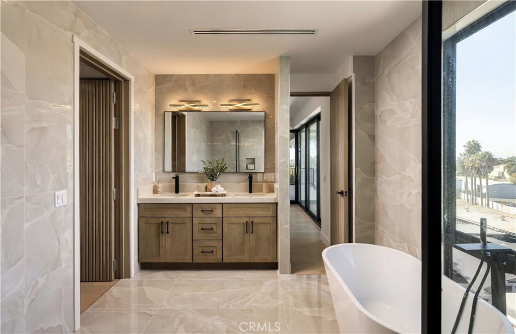 Primary: Double vanity: Warm wood cabinetry against onyx-look stone, with sculptural lighting. - 126 Calle Redondel, San Clemente CA 92672 - photo 44