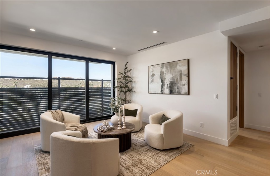 Full-height glass and warm oak floors create a relaxed gathering space. - 126 Calle Redondel, San Clemente CA 92672 - photo 52