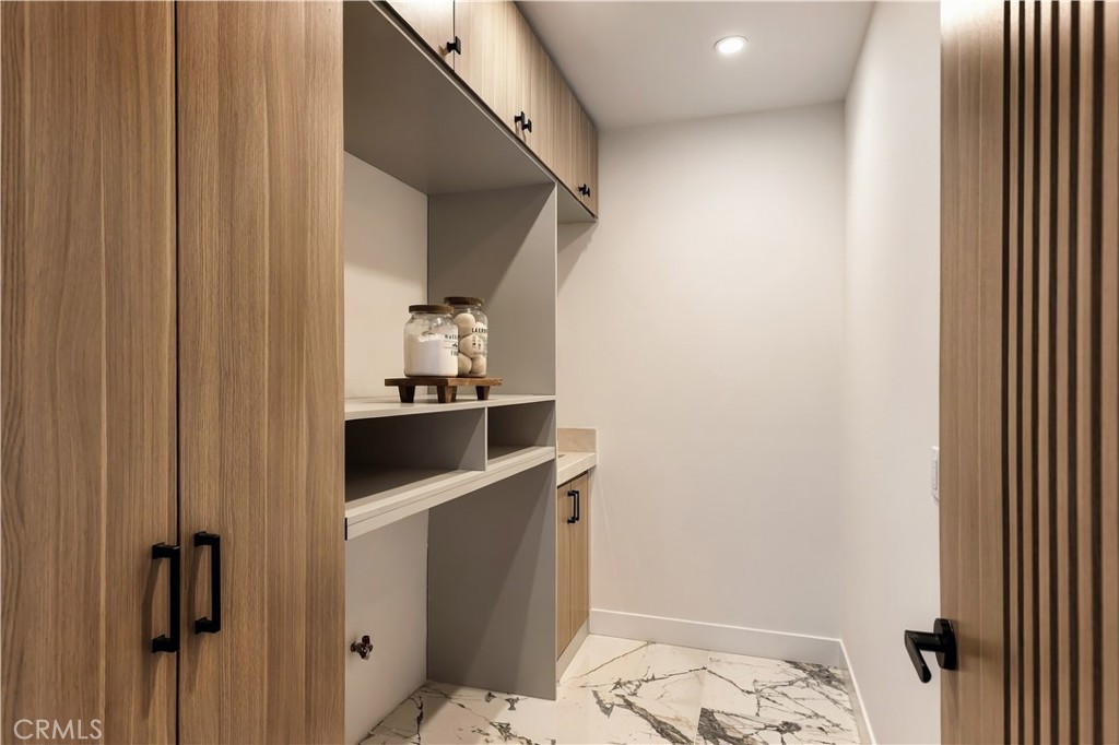 Laundry room with floor to ceiling cabinets and separate sink - 126 Calle Redondel, San Clemente CA 92672 - photo 53