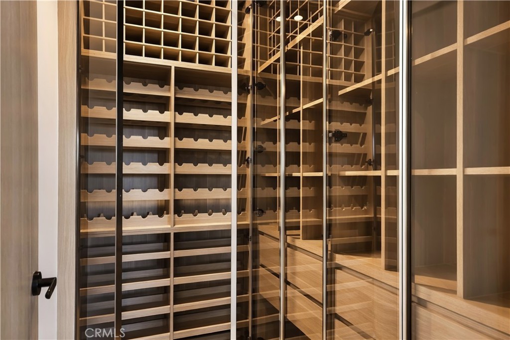 Wine room is glass-enclosed and fitted with custom oak racking, cubbies, and drawers. - 126 Calle Redondel, San Clemente CA 92672 - photo 58