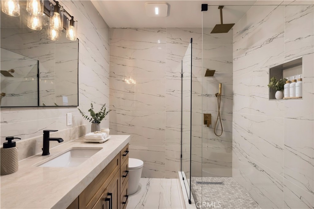 Frameless walk-in shower with brass rain head, handheld, and mosaic floor. - 126 Calle Redondel, San Clemente CA 92672 - photo 62