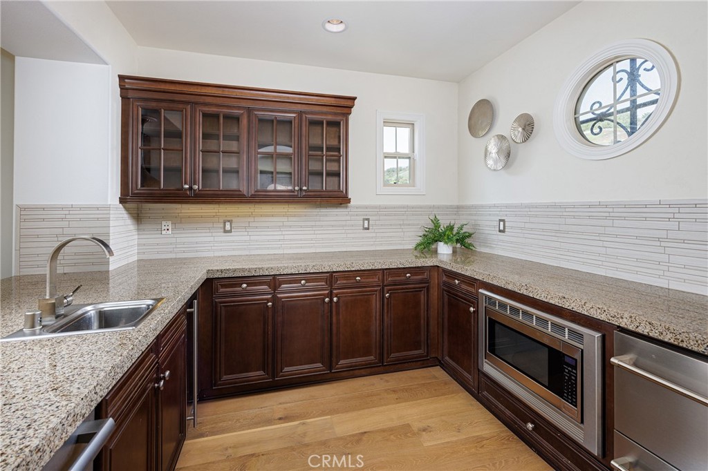 The upstairs playroom is outfitted with a second kitchen area - 18 Via Alcamo, San Clemente CA 92673 - photo 17