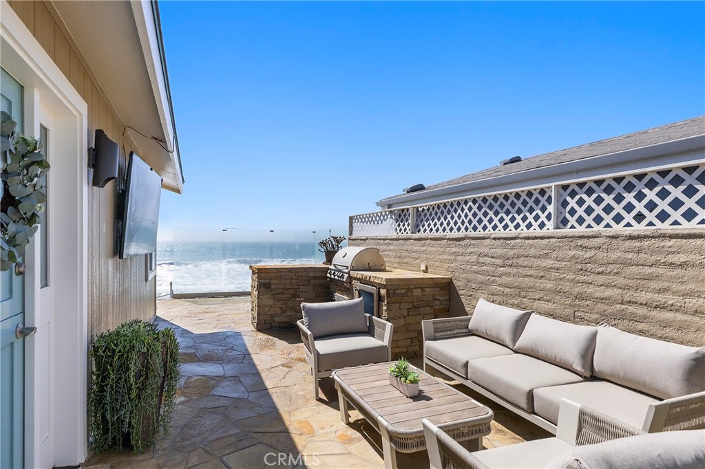 Entertain outdoors with the backdrop of the Pacific Ocean. New built-in grill with outdoor fridge, TV and glass wall - 1880 N El Camino Real #14, San Clemente CA 92672 - photo 5