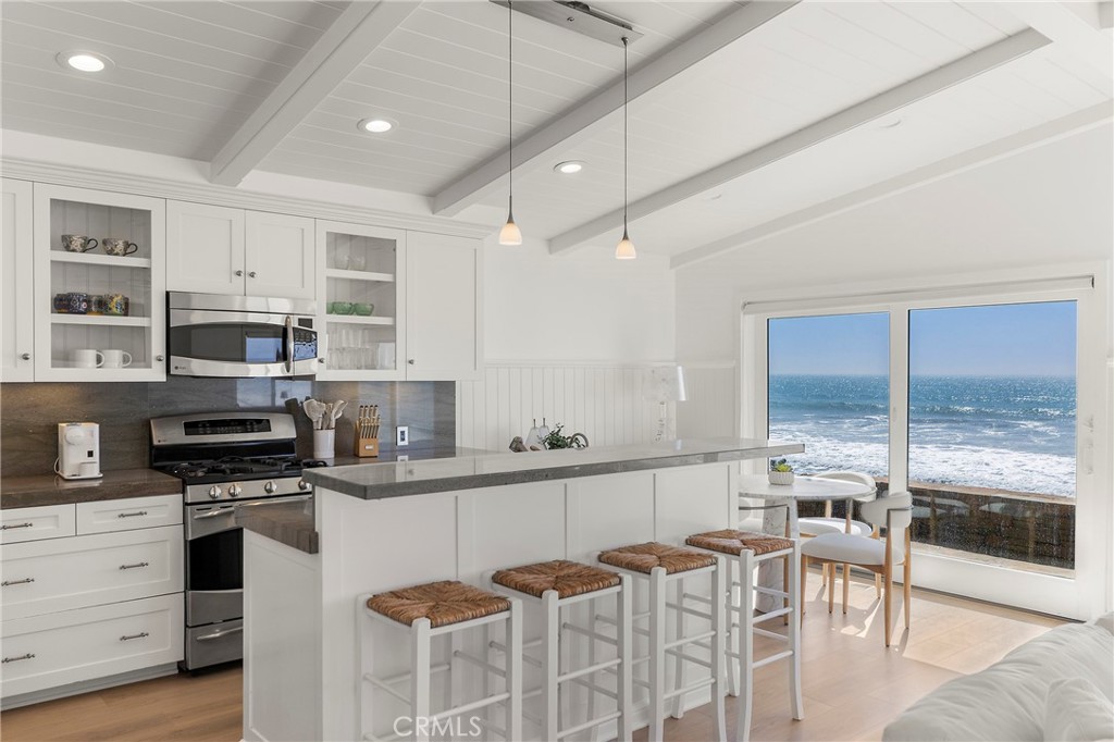 Modern kitchen with island-seating as well as dining area - 1880 N El Camino Real #14, San Clemente CA 92672 - photo 10