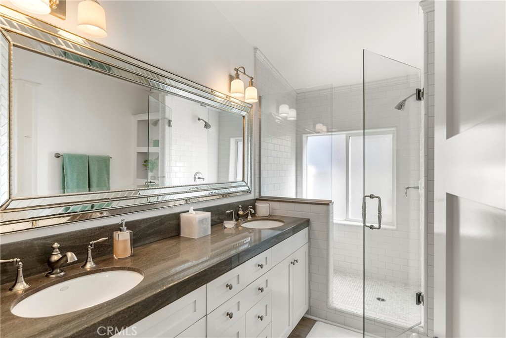 Primary bathroom with dual sinks and glass walk-in shower - 1880 N El Camino Real #14, San Clemente CA 92672 - photo 25