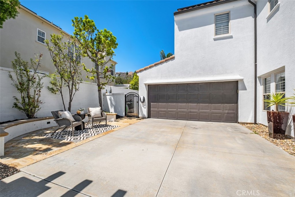Long driveway with courtyard, Tesla/EV Charger (installed in 2024), and two-car garage with epoxy flooring. - 19 Calle Verdadero, San Clemente CA 92673 - photo 9