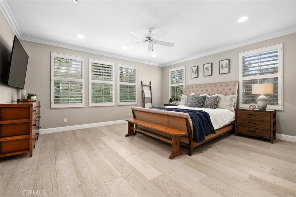 Primary bedroom features plantation shutters, ceiling fan, and hardwood flooring. - 19 Calle Verdadero, San Clemente CA 92673 - photo 23