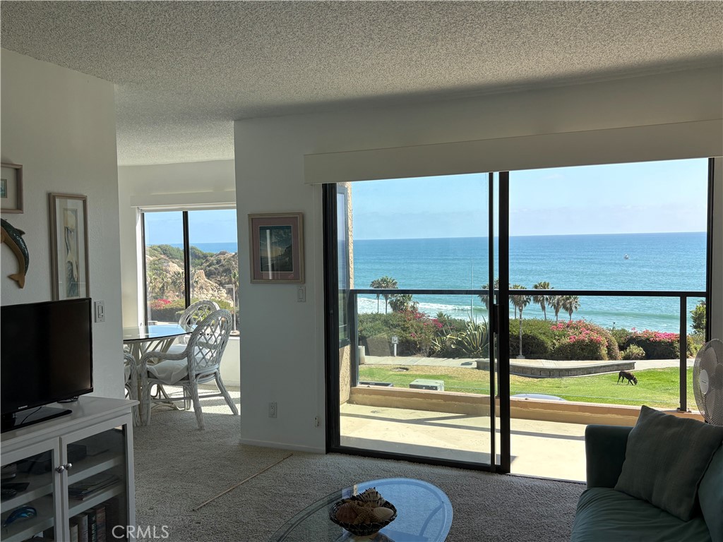 Large deck framed with glass spans entire width of​​‌​​​​‌​​‌‌​​‌‌​​‌‌​​‌​​​‌‌​‌​​​​‌‌​‌​​ condo - 250 Avenida Lobeiro E, San Clemente CA 92672 - photo 5