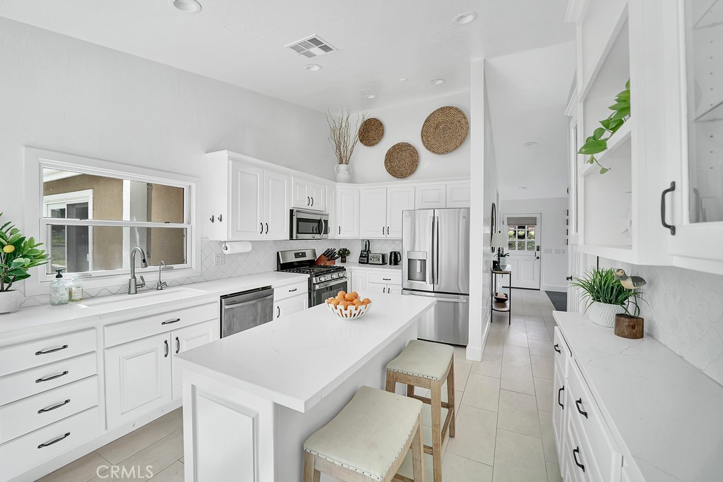 Island and plenty of cabinet space.Extra Refrigerator/Freezer and large panty in garage. - 2897 Calle Heraldo, San Clemente CA 92673 - photo 5