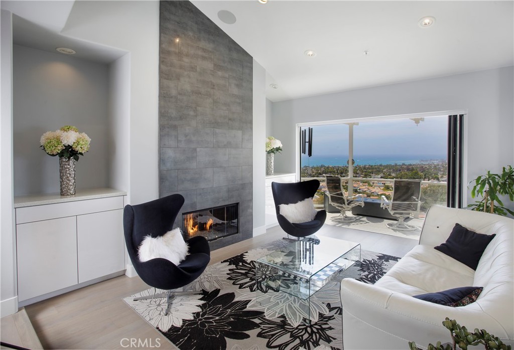 Walls of glass frame sweeping coastal views while a striking contemporary fireplace creates an inviting focal point for - 3 Via Pasa, San Clemente CA 92673 - photo 5