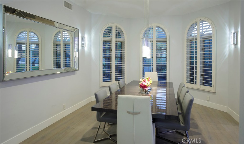 The formal dining room is framed by graceful arched windows with plantation shutters, creating an elegant setting for in - 3 Via Pasa, San Clemente CA 92673 - photo 6