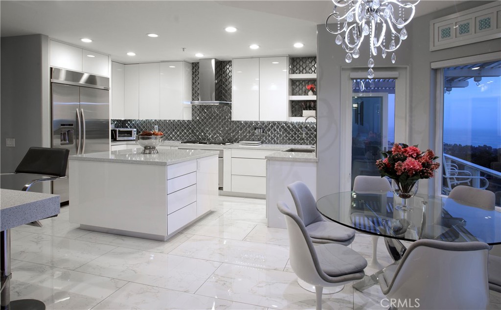 The remodeled kitchen features sleek custom cabinetry, waterfall quartz countertops, premium stainless-steel appliances, - 3 Via Pasa, San Clemente CA 92673 - photo 7