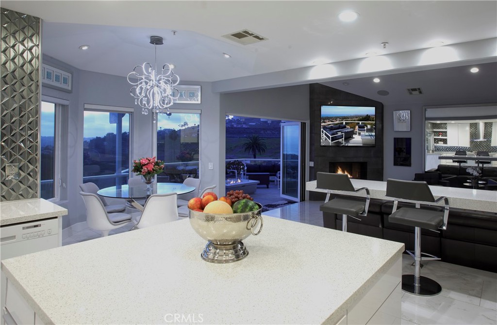 An expansive center island, designer finishes, and seamless indoor-outdoor flow define the home's main living spaces. - 3 Via Pasa, San Clemente CA 92673 - photo 8