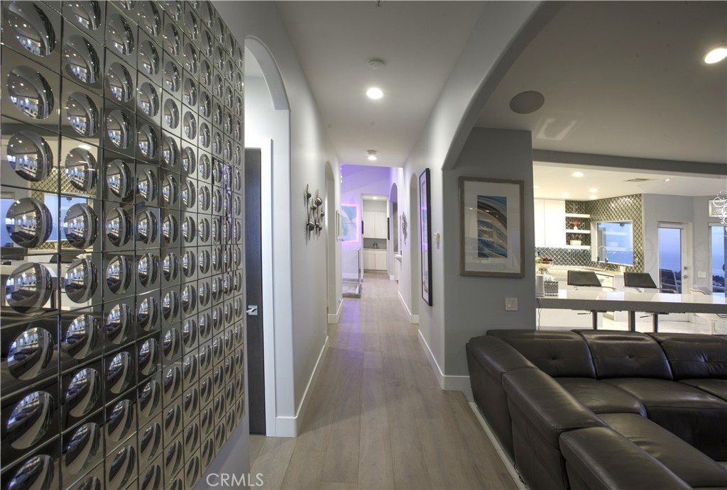 A light-filled gallery hall highlights the home's open floor plan and refined contemporary aesthetic. - 3 Via Pasa, San Clemente CA 92673 - photo 12
