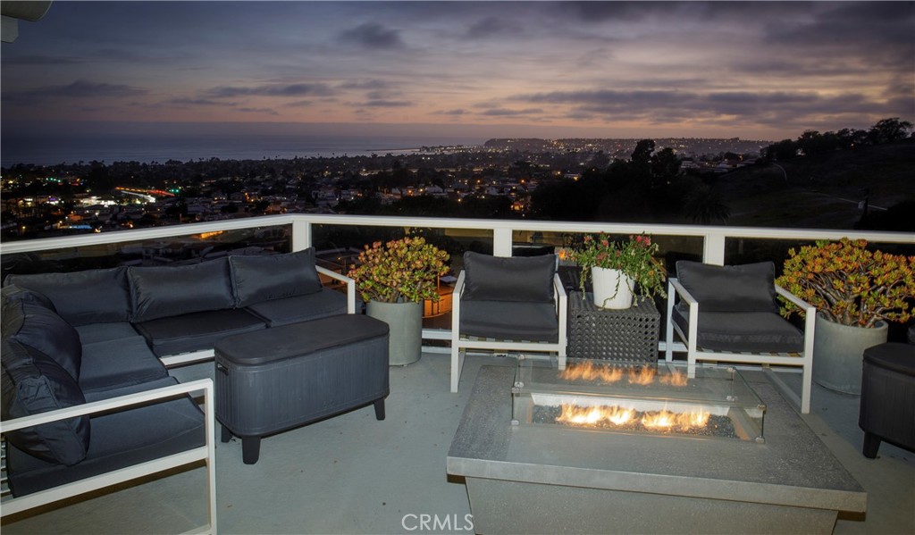 Expansive ocean-view terrace extends the home's living space outdoors, offering multiple seating areas, a contemporary f - 3 Via Pasa, San Clemente CA 92673 - photo 15
