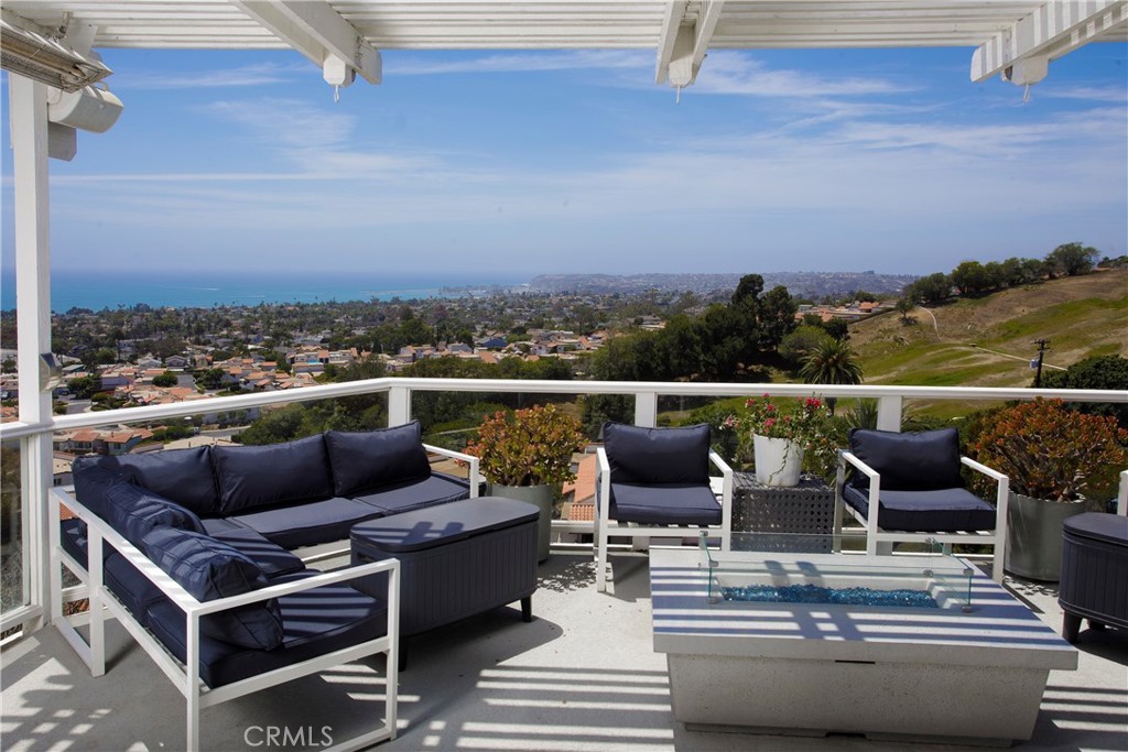 Expansive ocean-view terrace extends the home's living space outdoors, offering multiple seating areas, a contemporary f - 3 Via Pasa, San Clemente CA 92673 - photo 16