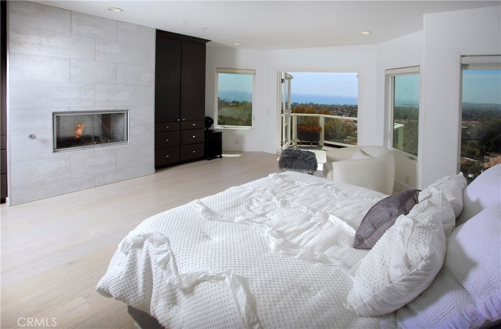 Wake to coastal views from the serene primary suite, complete with a fireplace, sitting area, and direct terrace access. - 3 Via Pasa, San Clemente CA 92673 - photo 18