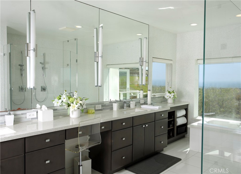 The spa-inspired primary bath features a dual-sink vanity, oversized glass-enclosed shower, soaking tub, and peaceful co - 3 Via Pasa, San Clemente CA 92673 - photo 19
