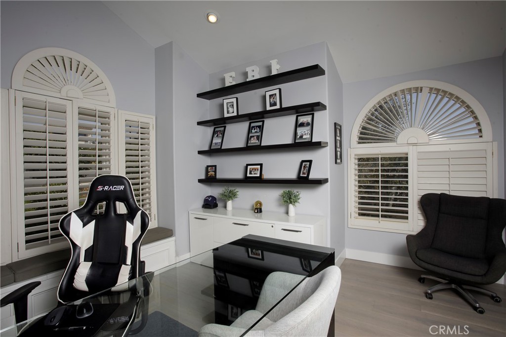 The dedicated office is thoughtfully designed with custom cabinetry, floating shelves, and a charming window seat, ideal - 3 Via Pasa, San Clemente CA 92673 - photo 20