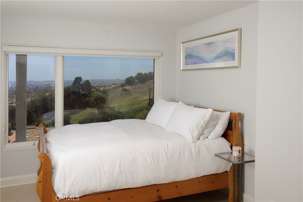 A bright and inviting guest bedroom is thoughtfully positioned to capture tranquil hillside and ocean views. - 3 Via Pasa, San Clemente CA 92673 - photo 23