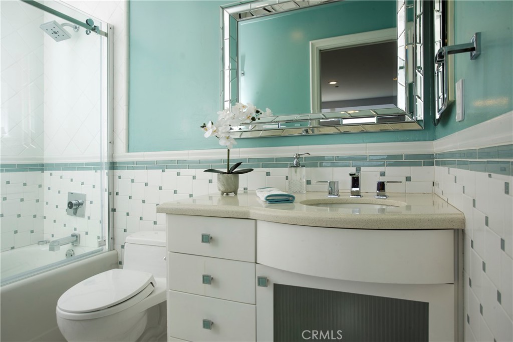 Finished with crisp white cabinetry, designer tile, and soft coastal-inspired accents, this full guest bathroom offers a - 3 Via Pasa, San Clemente CA 92673 - photo 27