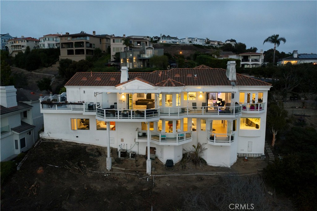 The rear elevation showcases multiple levels of view-oriented living, with expansive terraces and walls of glass designe - 3 Via Pasa, San Clemente CA 92673 - photo 31