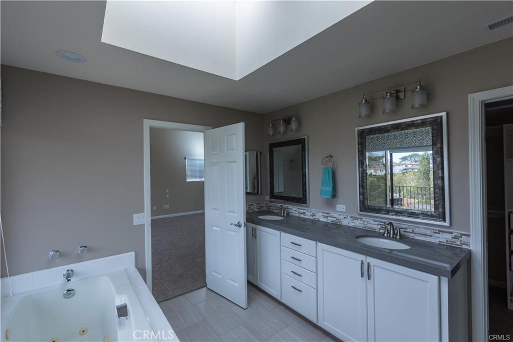 Primary bedroom , Jacuzzi tub over looking Coastal Canyon with walk in closet and walk in shower with glass enclosure. - 303 La Rambla, San Clemente CA 92672 - photo 6