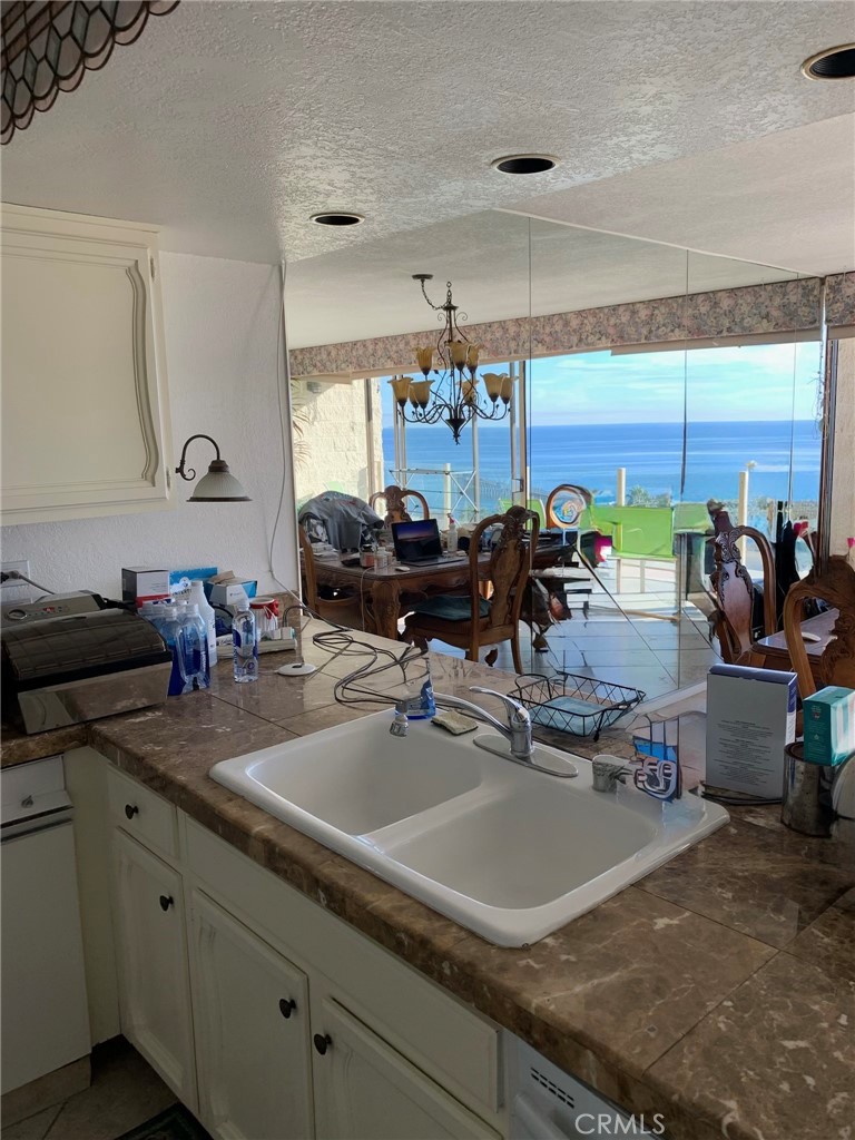 Kitchen view into mirror with reflection of ocean. - 405 Avenida Granada 404, San Clemente CA 92672 - photo 10