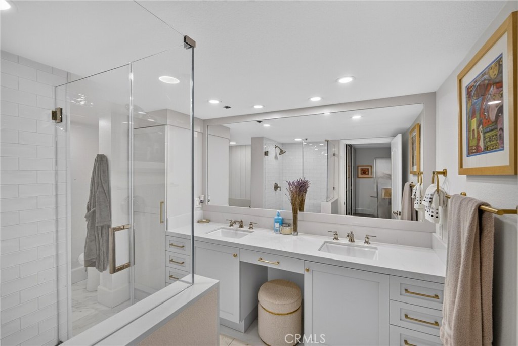 A spa-like primary bathroom suite with glassed-in shower, dual vanities, soaking tub, stone countertops, bronze hardware - 409 Arenoso 2, San Clemente CA 92672 - photo 30