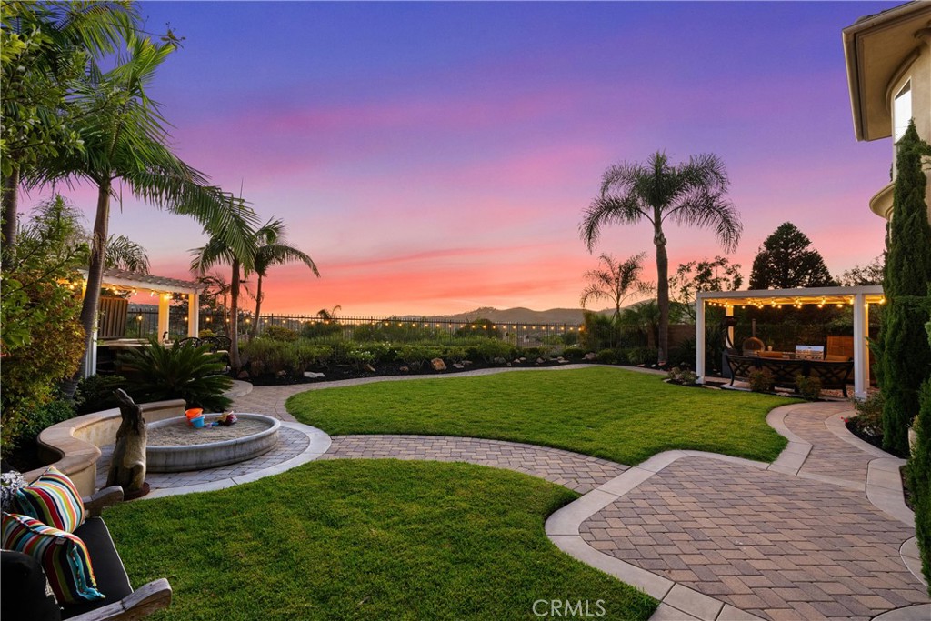 Desirable southwest-facing rear yard captures daily sunlight and colorful sunset skies with panoramic hills, city lights - 6614 Colina Puesta, San Clemente CA 92673 - photo 3