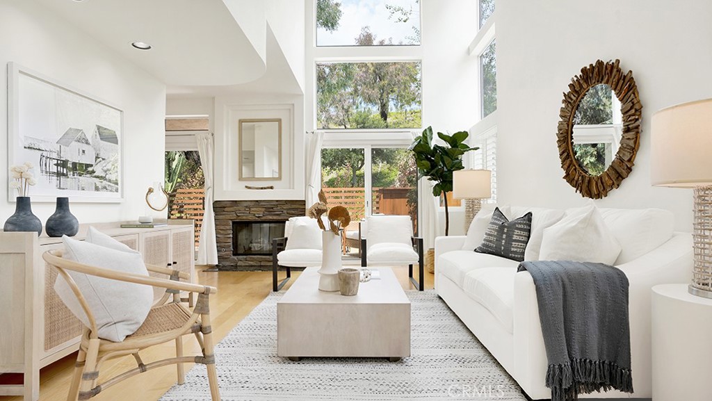 Beautifully staged, the living room showcases 20 foot ceilings with plenty of natural light. - 900 Via Presa, San Clemente CA 92672 - photo 1