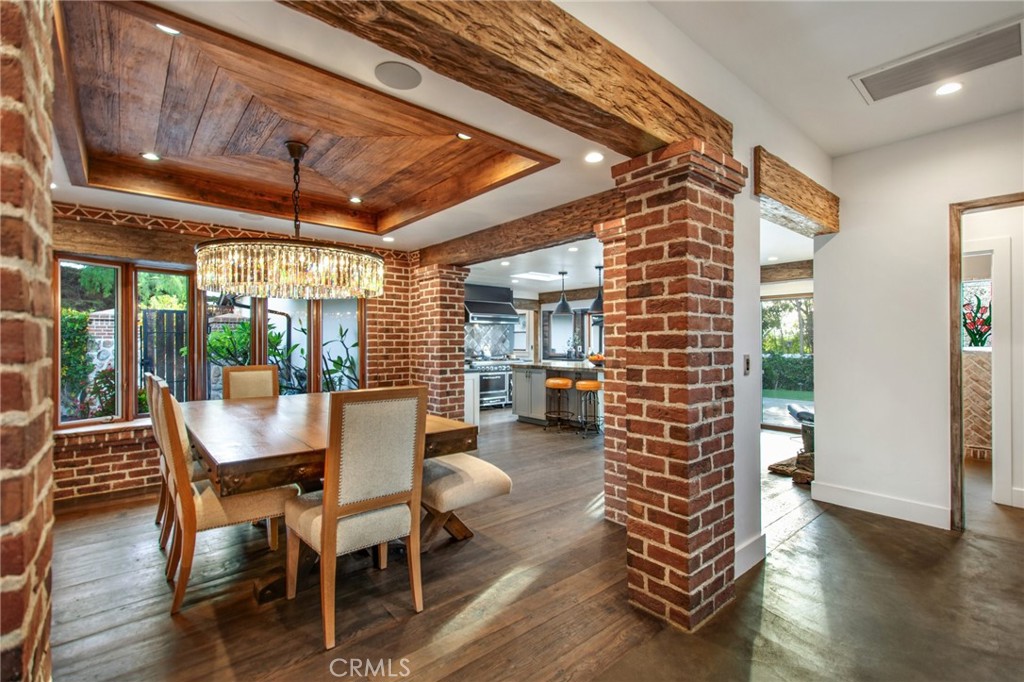 View into Formal Dining Room - Reclaimed destressed hardwood flooring, brick accents, custom finishes - 27151 Mission Hills Drive, San Juan Capistrano CA 92675 - photo 5