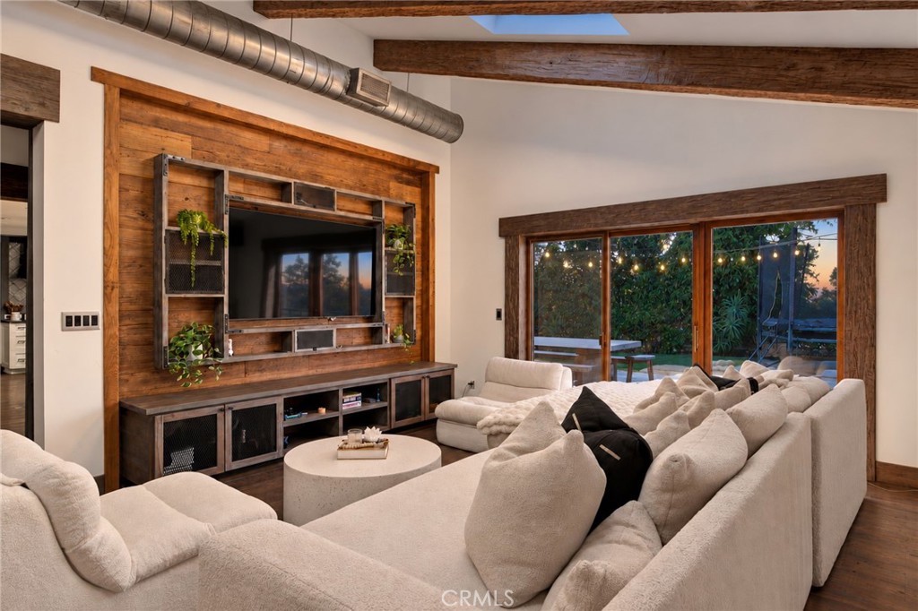 Family room has custom built in entertainment unit - access to the side yard with views - 27151 Mission Hills Drive, San Juan Capistrano CA 92675 - photo 17