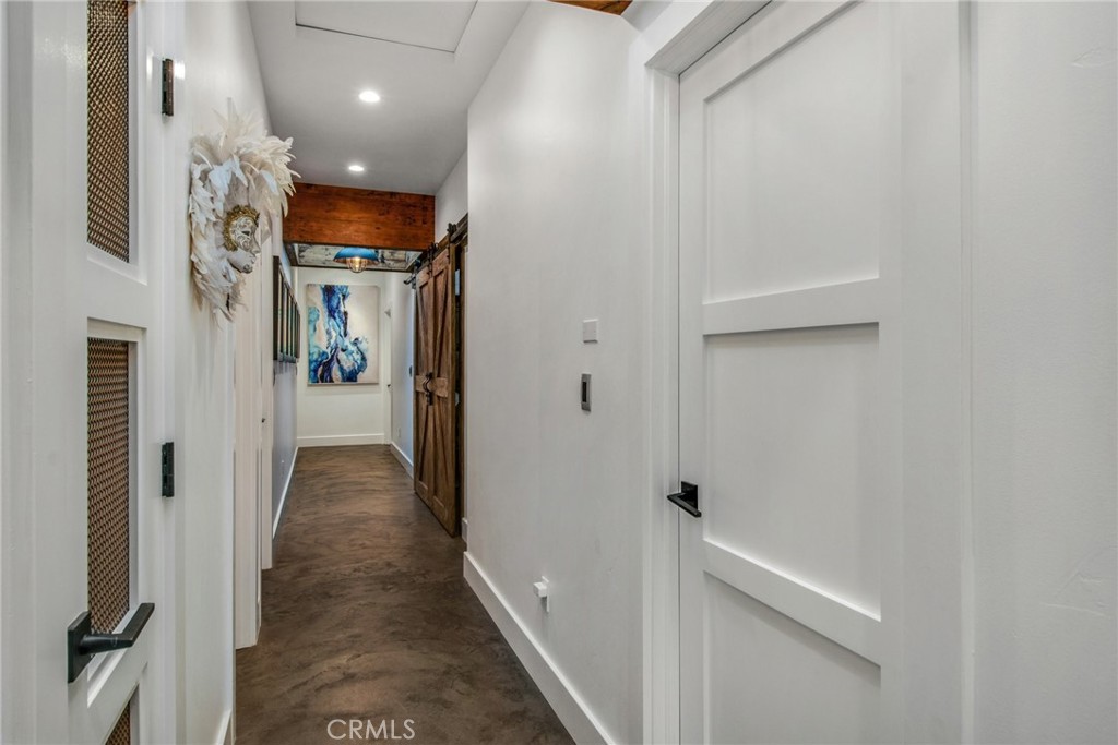 Hallway to the other five bedrooms with concrete flooring - 27151 Mission Hills Drive, San Juan Capistrano CA 92675 - photo 18
