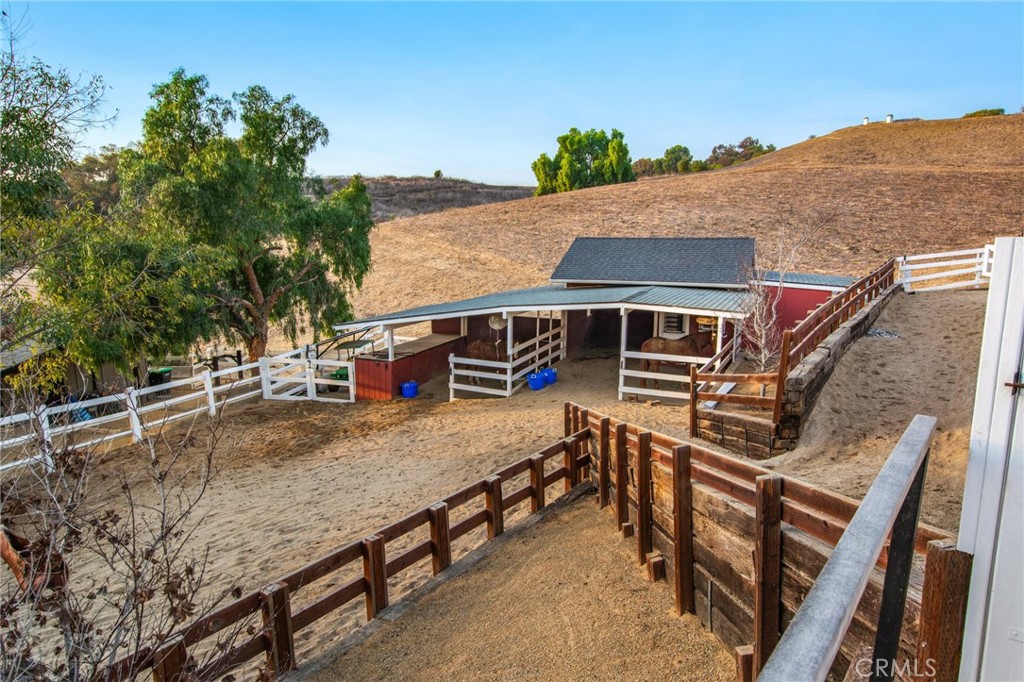 View of the barn and paddock below - 27151 Mission Hills Drive, San Juan Capistrano CA 92675 - photo 27