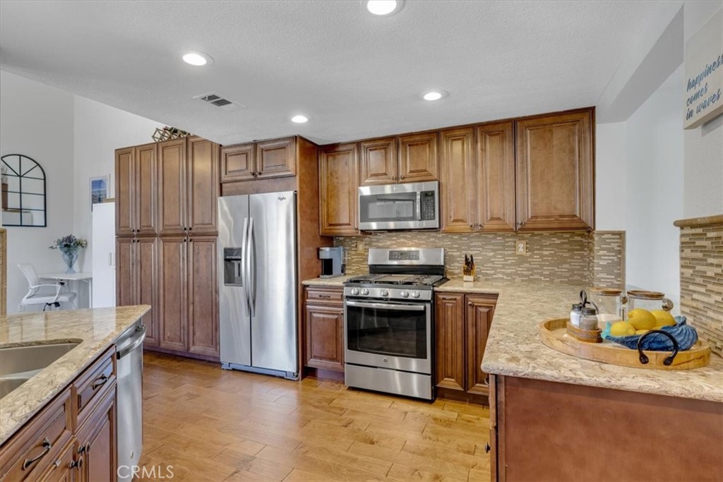 The kitchen was expanded into the former family/nook area and includes additional storage and pantry space! - 27355 Paseo Laguna, San Juan Capistrano CA 92675 - photo 14
