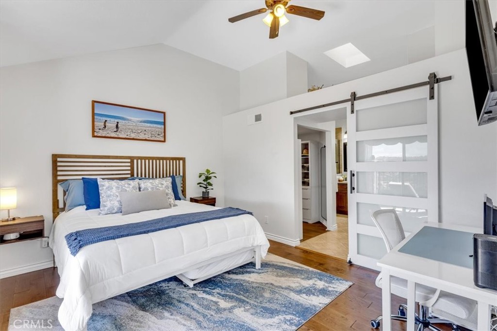 The spacious primary suite is located on the main floor and includes ceiling fan and barn door to primary bath and walk- - 27355 Paseo Laguna, San Juan Capistrano CA 92675 - photo 21